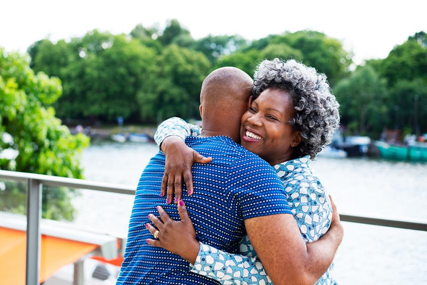 Senior woman hugging man